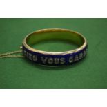 A yellow metal blue enamel and gem set hinged bangle 'Dieu Vous Garde'.