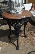 A cast iron and wooden pub table.