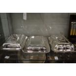 Three plated entree dishes with covers together with a cased set of twelve fish knives and forks.