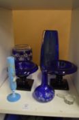 Blue glass pedestal salts and other items.