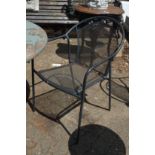 A set of four black painted wrought iron garden chairs.