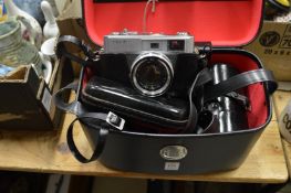 A Minolta camera with case and accessories.