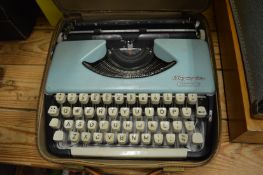 An Olympia Splendid 99 typewriter and a sewing machine.