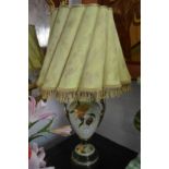 A pair of green pottery urn shaped table lamps with shades.