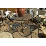 A black painted wrought iron circular garden table and four armchairs.