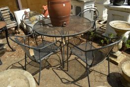 A black painted wrought iron circular garden table and four armchairs.