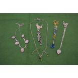 A silver and crystal heart shaped pendant and chain and various other necklaces.