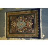 A small Persian rug 90cm x 70cm.