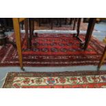 A modern Bokhara style carpet 185cm x 110cm.