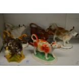Five various pottery cow creamers.