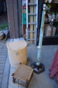 A Chinese style floor standing lamp, wicker laundry basket and a small stool.