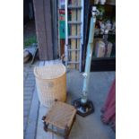 A Chinese style floor standing lamp, wicker laundry basket and a small stool.