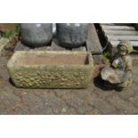 A small bird bath modelled as a kneeling girl holding a shell together with a rectangular planter.