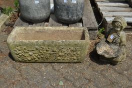 A small bird bath modelled as a kneeling girl holding a shell together with a rectangular planter.