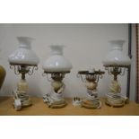 Three oil lamp style electric lights.