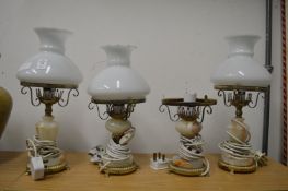 Three oil lamp style electric lights.