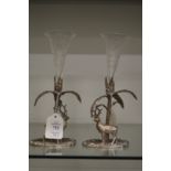 A pair of plated bud vases, the bases modelled as deer by a tree, each with engraved glass posy