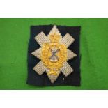 A silver and gilt Black Watch badge 'Nemo Me Impure Lacessit'.