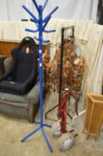 A blue painted tubular steel coat rack and a golf bag trolley.