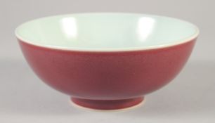 A CHINESE COPPER RED GLAZE PORCELAIN BOWL, incised character mark to base, 17.5cm diameter.