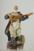 A CHINESE SHIWAN GLAZED POTTERY FIGURE OF A MUSICIAN, 22.5cm high.