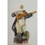 A CHINESE SHIWAN GLAZED POTTERY FIGURE OF A MUSICIAN, 22.5cm high.