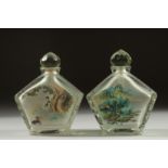 A PAIR OF CHINESE REVERSE GLASS PAINTED SNUFF BOTTLES AND STOPPERS, finely painted with scenes of