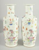 A PAIR OF CHINESE FAMILLE ROSE PORCELAIN VASES, decorated with vases and various objects as well