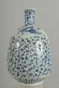 A JAPANESE BLUE AND WHITE PORCELAIN BOTTLE VASE, with deer and scrolling foliate decoration, 21cm