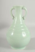 A CHINESE CELADON GLAZE TWIN HANDLE VASE, 26.5cm high.