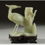 A CARVED JADE FIGURE OF A STORK on a fitted wooden stand, 15cm high overall.