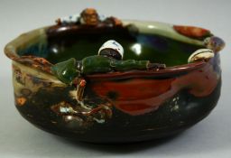 A JAPANESE SUMIDA POTTERY BOWL, with two partly glazed figures to either side of the bowl, signed to