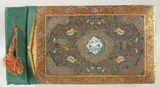 A PERSIAN METAL MOUNTED PAINTED WOODEN ALBUM, with central inset enamel panel painted with flora and
