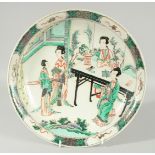 A CHINESE KANGXI FAMILLE VERTE PORCELAIN DISH, painted with female figures, 29cm diameter.