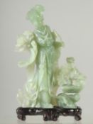 A CHINESE CARVED JADE FEMALE FIGURE ON STAND, jade 21cm high.