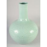 A VERY LARGE CHINESE CELADON GLAZED PORCELAIN VASE, with carved decoration and six-character mark to
