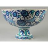 A LARGE TURKISH OTTOMAN GLAZED POTTERY CENTRE PIECE PEDESTAL BOWL, painted with foliate motifs, 42.