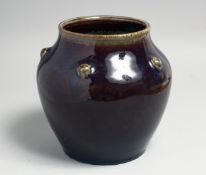 A CHINESE FLAMBE GLAZE PORCELAIN JAR, the shoulder with five raised bosses, the base with six-