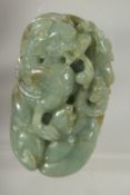 A CHINESE CARVED JADE PEBBLE, depicting a dragon, 7.5cm x 4.5cm.
