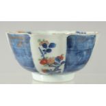 A 19TH CENTURY JAPANESE BLUE AND WHITE IMARI PORCELAIN BOWL, decorated with panels of flora,