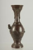 A SMALL BRONZE TWIN HANDLE VASE, with relief dragon, 16.5cm high.