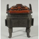 A CHINESE BRONZE TWIN HANDLE CENSER WITH HARDWOOD COVER, the censer with archaic style decoration