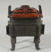 A CHINESE BRONZE TWIN HANDLE CENSER WITH HARDWOOD COVER, the censer with archaic style decoration