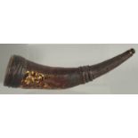 AN ANTIQUE TURKISH LEATHER AND TORTOISESHELL POWDER HORN, 32cm long.