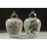 A GOOD PAIR OF CHINESE REVERSE GLASS PAINTED JARS, finely painted with landscape scenes and an