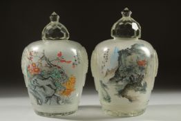 A GOOD PAIR OF CHINESE REVERSE GLASS PAINTED JARS, finely painted with landscape scenes and an