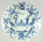 A CHINESE KANGXI BLUE AND WHITE PORCELAIN DISH, painted with figures and panels of flora, 14cm