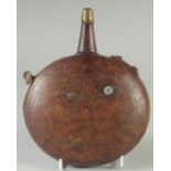 A 19TH CENTURY ISLAMIC OTTOMAN LEATHER FLASK, 18cm wide.