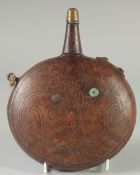 A 19TH CENTURY ISLAMIC OTTOMAN LEATHER FLASK, 18cm wide.