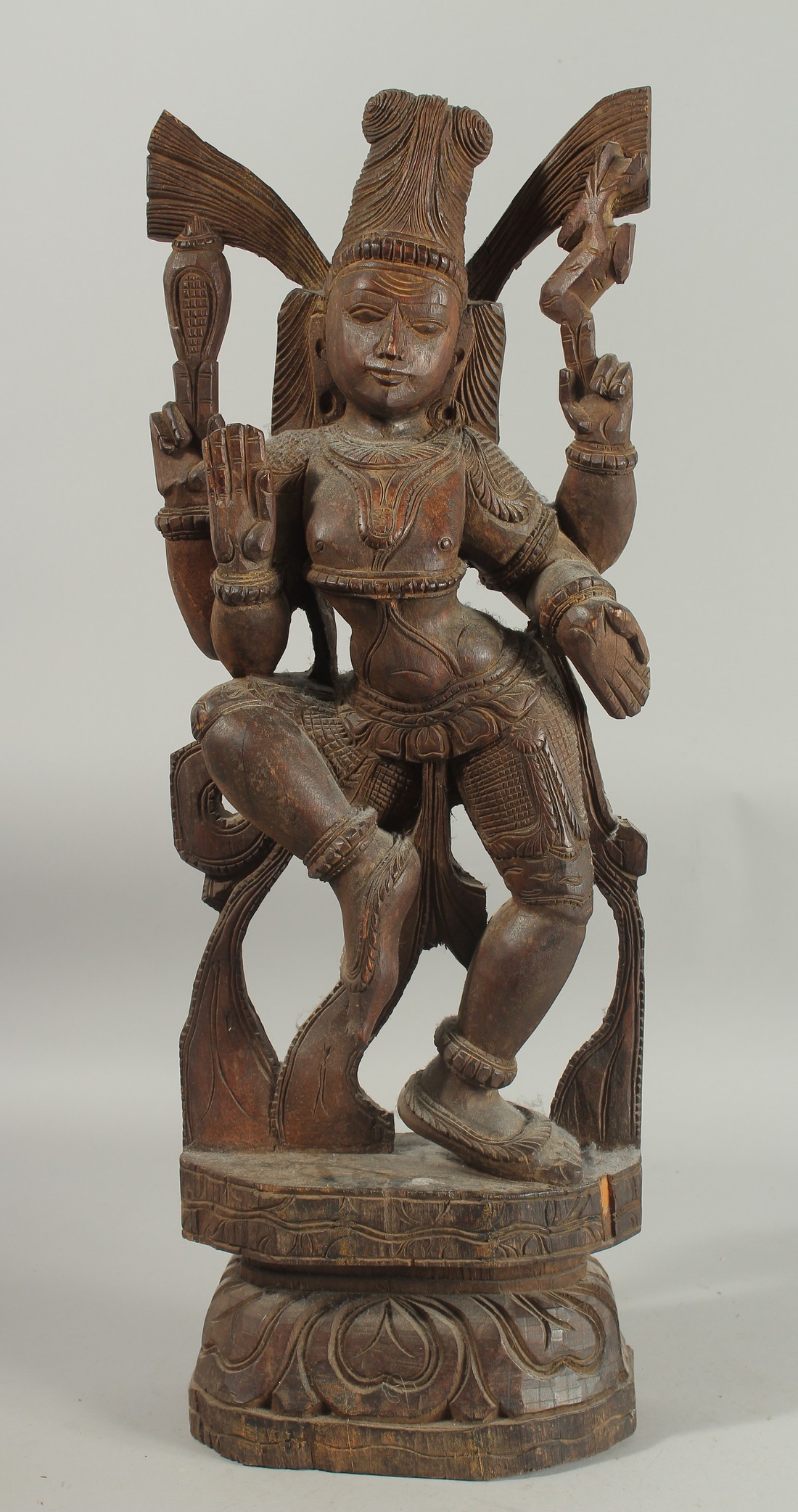 A 19TH CENTURY WOODEN CARVING OF SHIVA, 61cm high.